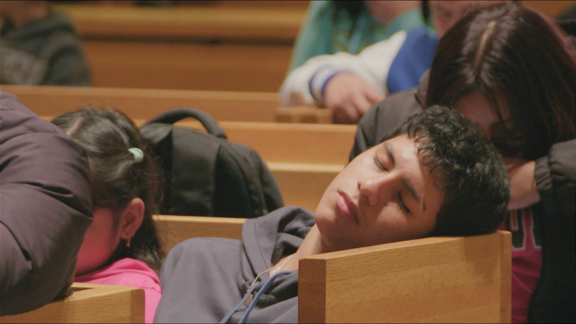 Een migrant die op een slaapplek wacht in New York.