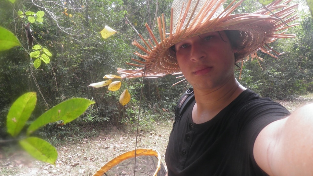 Bart catches butterflies for research in Cambodia.