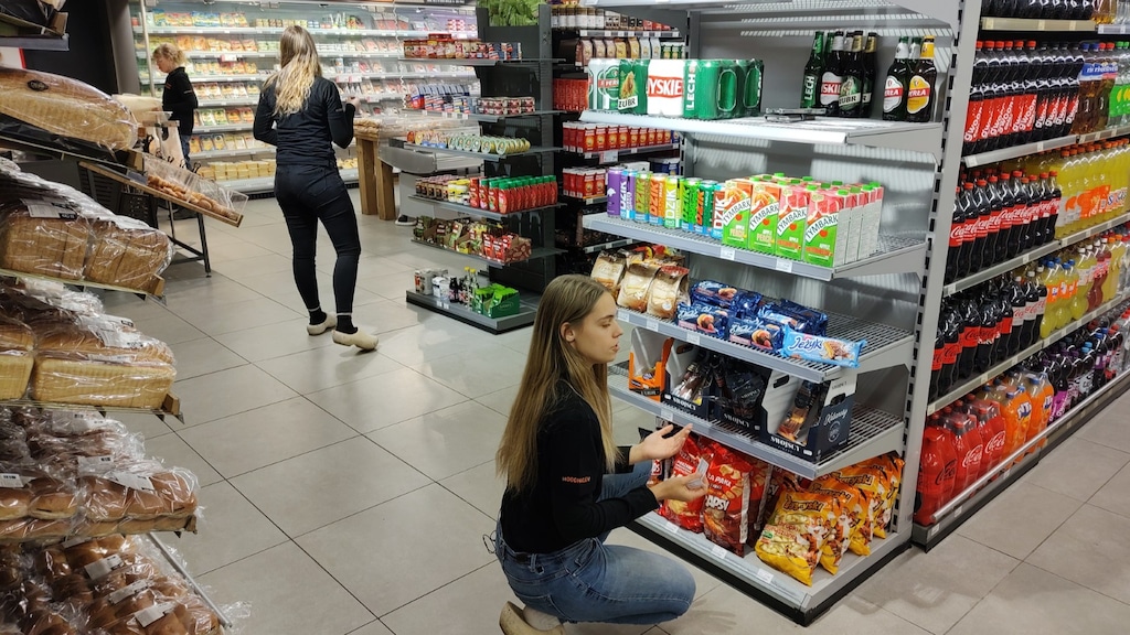 Ilse en Sanne vullen vakken in hun supermarkt.